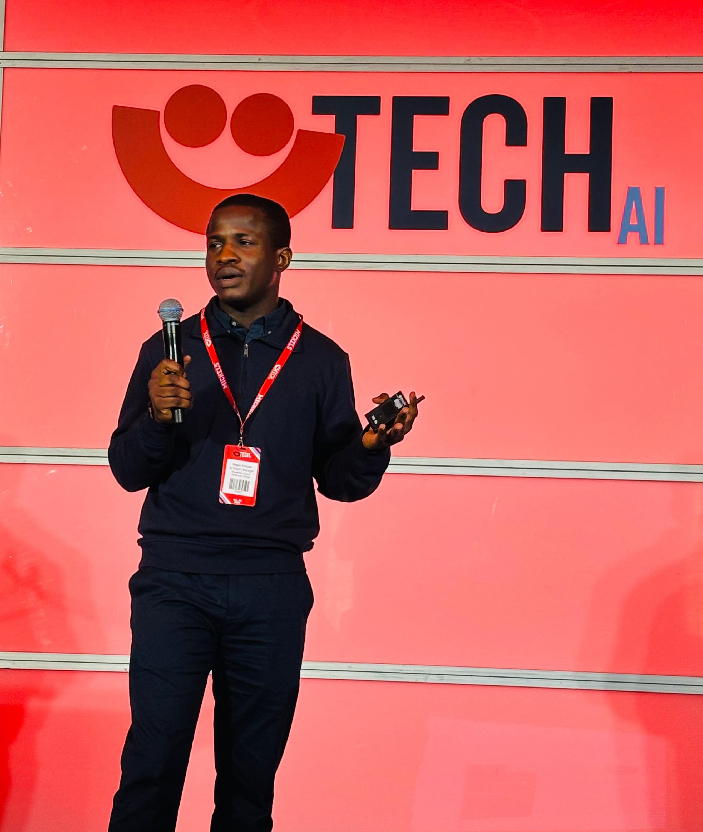 Segun Onilude speaking on stage at a TECH AI conference